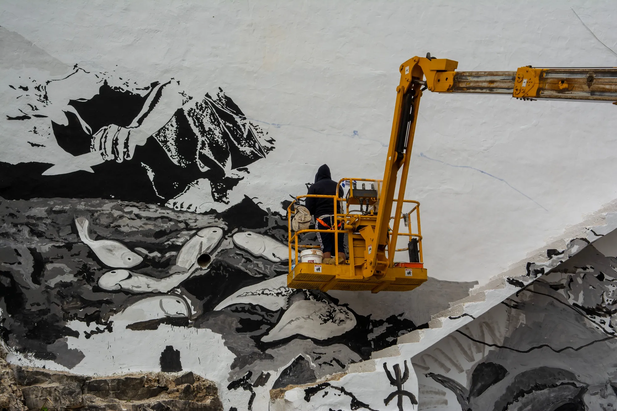 A mural taking shape in public space.